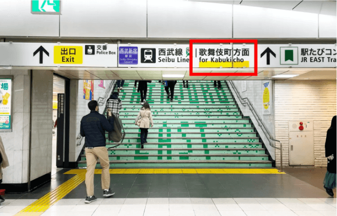 歌舞伎町方面と書かれた案内板がある階段を上がって、東口に到着
